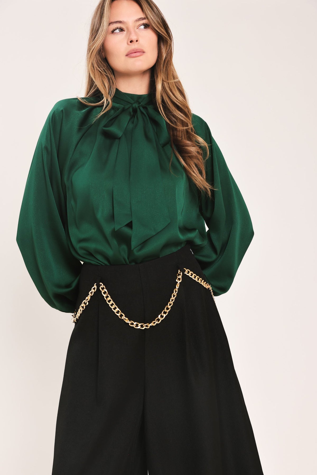 Hunter green tie-neck raglan top with high bow neckline and draped front
