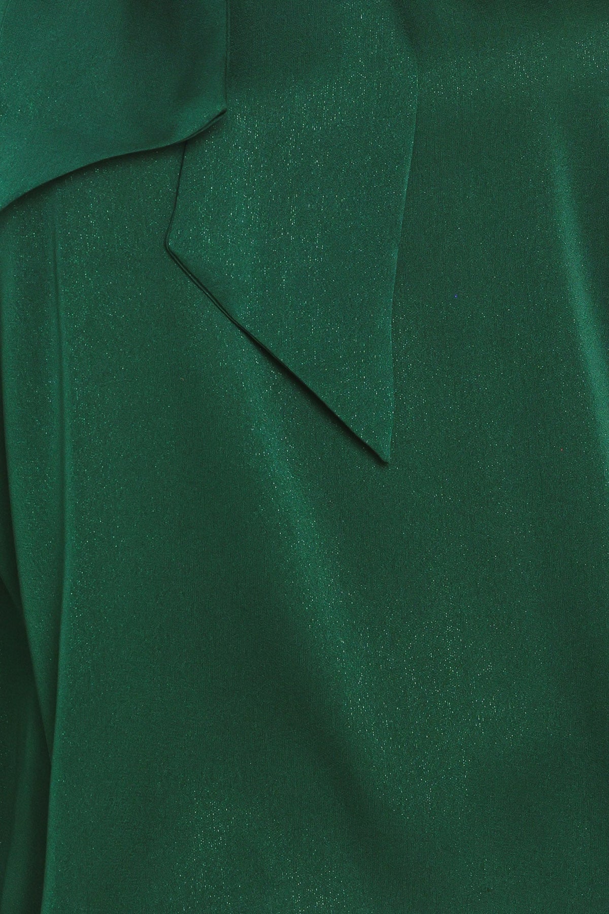 Close-up of hunter green satin tie-neck top fabric with seam and panel stitching