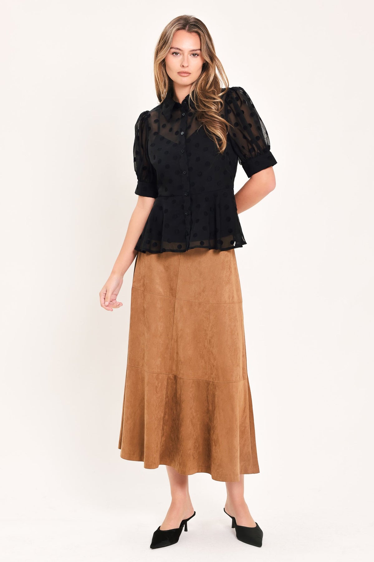 Black polka-dot woven button top with short puff sleeves and peplum hem.
