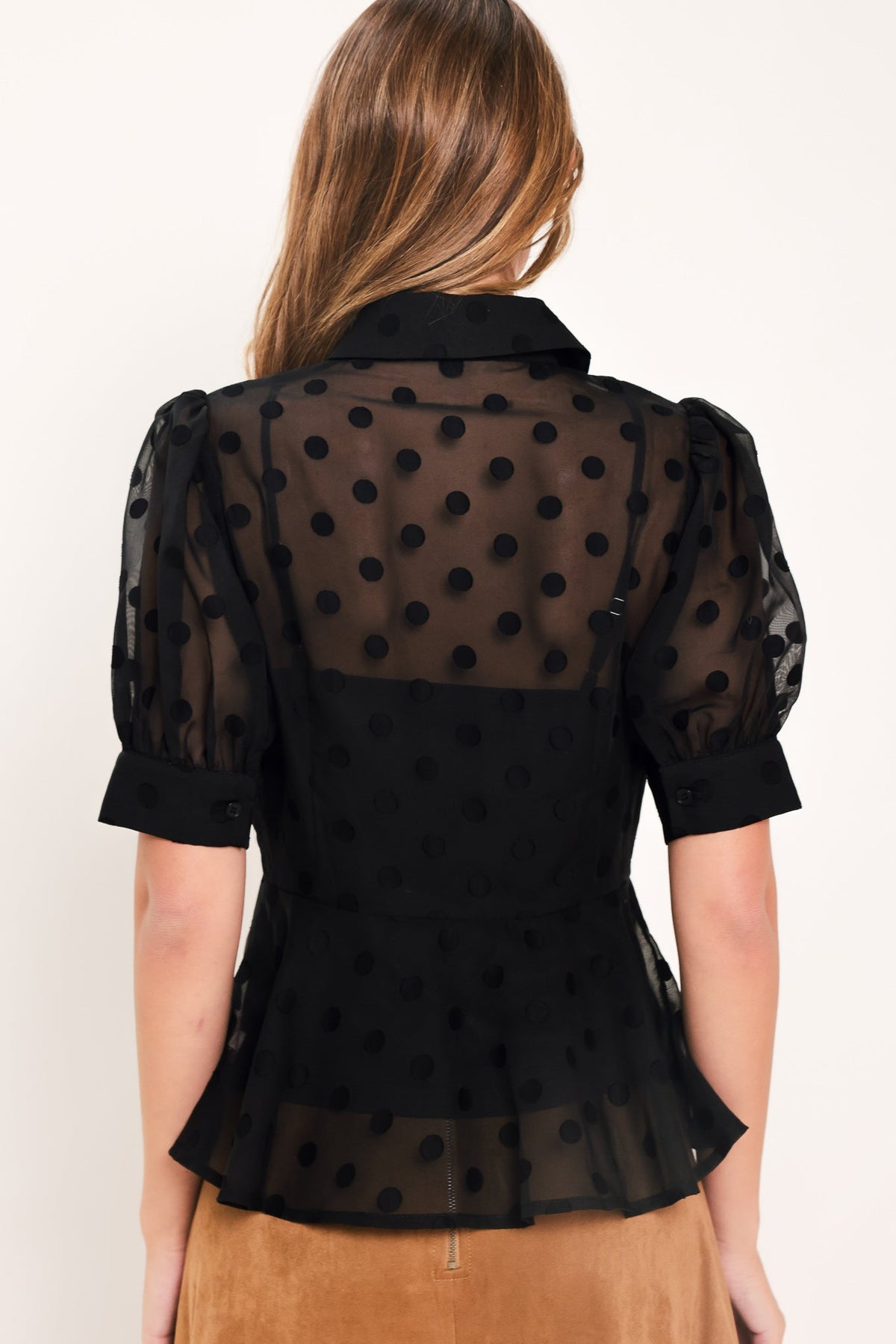 Black polka-dot woven top with back yoke, puff sleeves, and button placket.