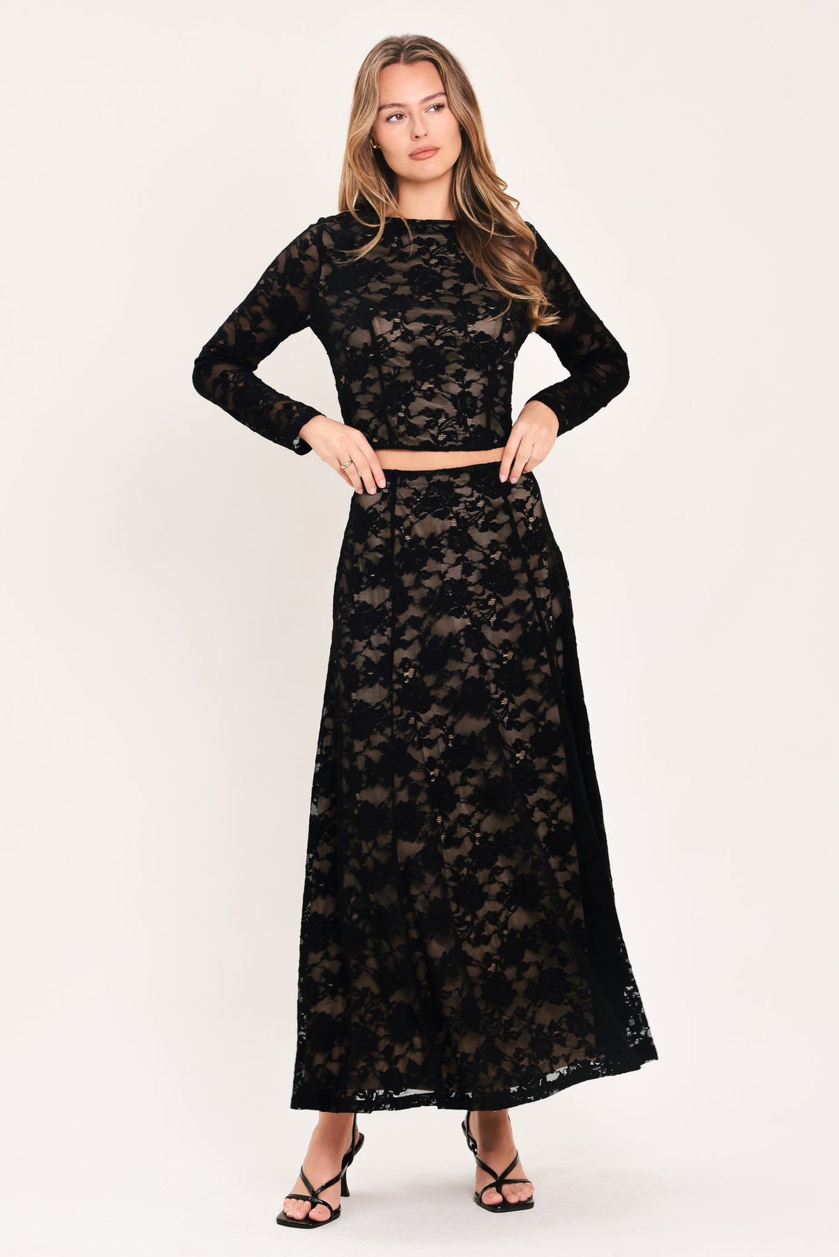 Black floral lace long-sleeve crop top with high neckline and fitted cropped hem