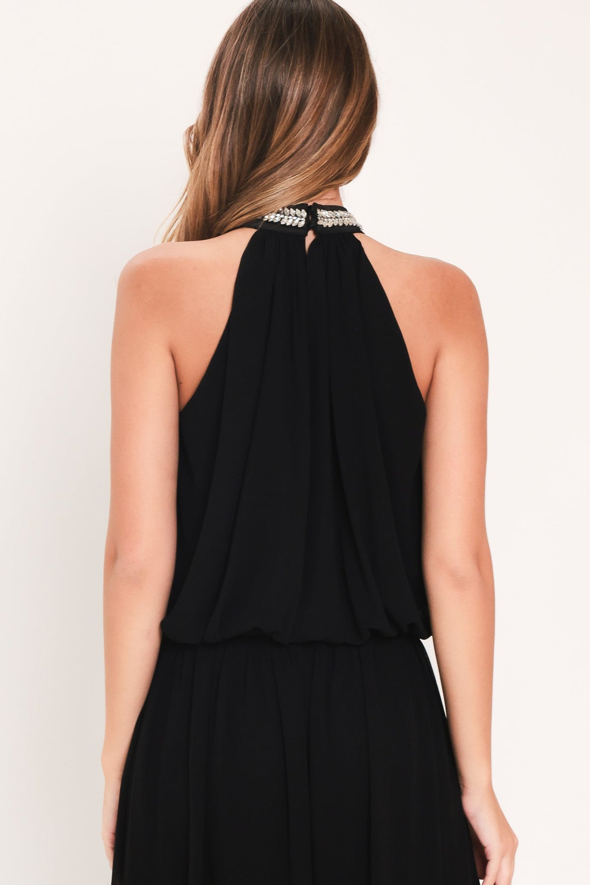 Black halter top and wide-leg pants set, open back with rhinestone neck detail