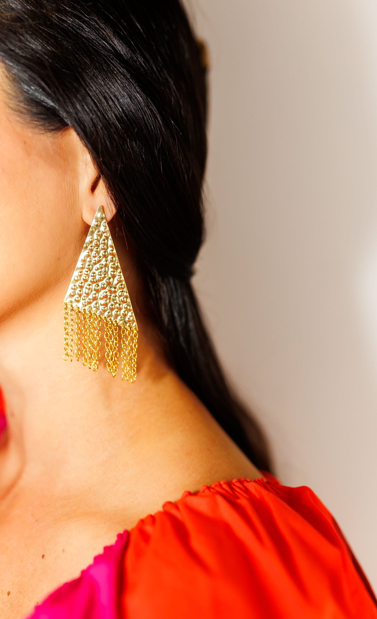 The Daniella 22k gold plated tassel earrings on a women's ear Lux Lovely