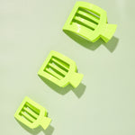 Set of three neon green flat square hair clips with ridged teeth