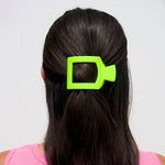 Neon lime flat square hair clip holding dark hair at the crown