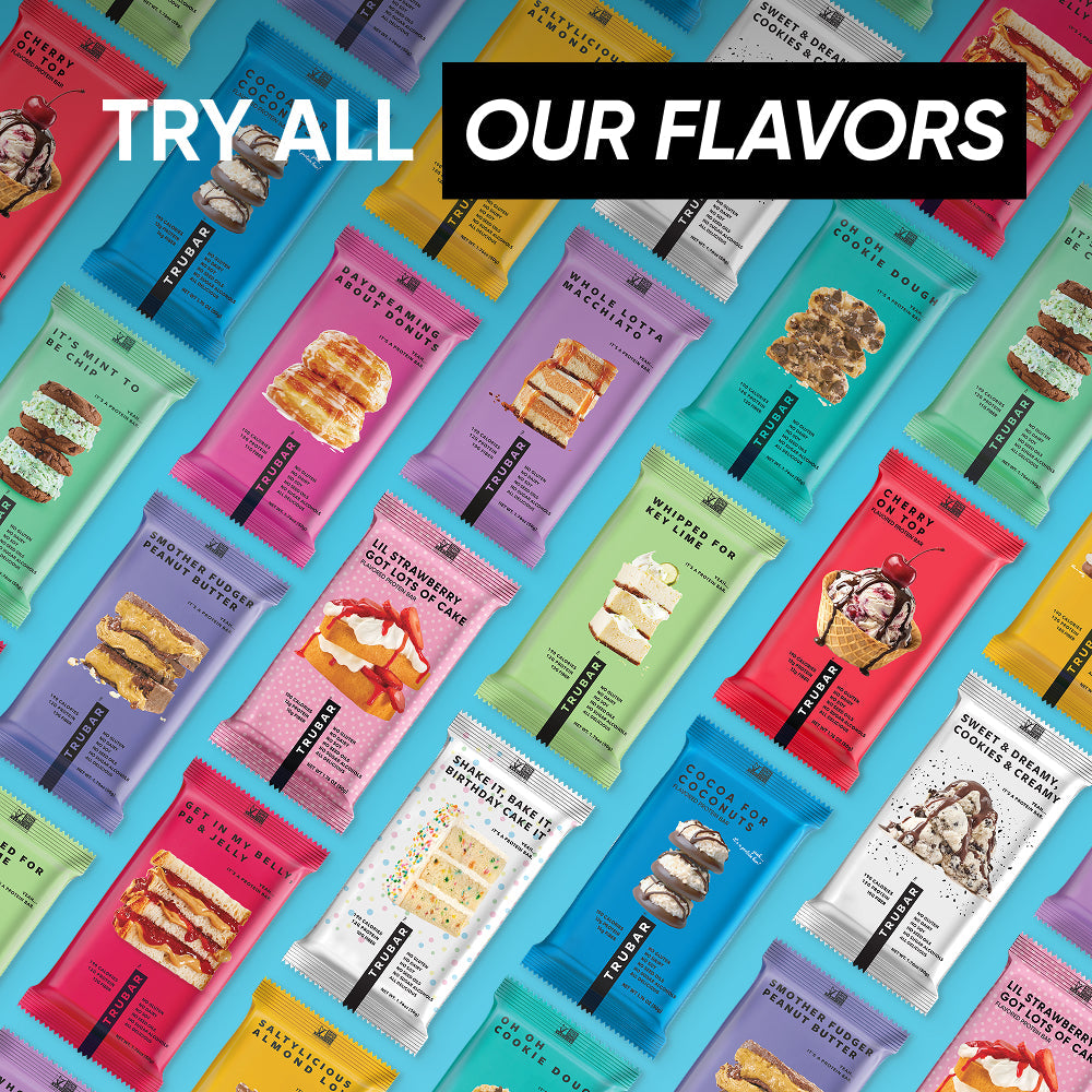 Assortment of TRUBAR protein bars lined up in colorful packaging variety display