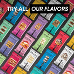 Assorted TRUBAR protein bar boxes and pouches on a colorful display