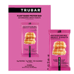 TRUBAR plant-based protein bar packaging set with pink donut flavor graphics.