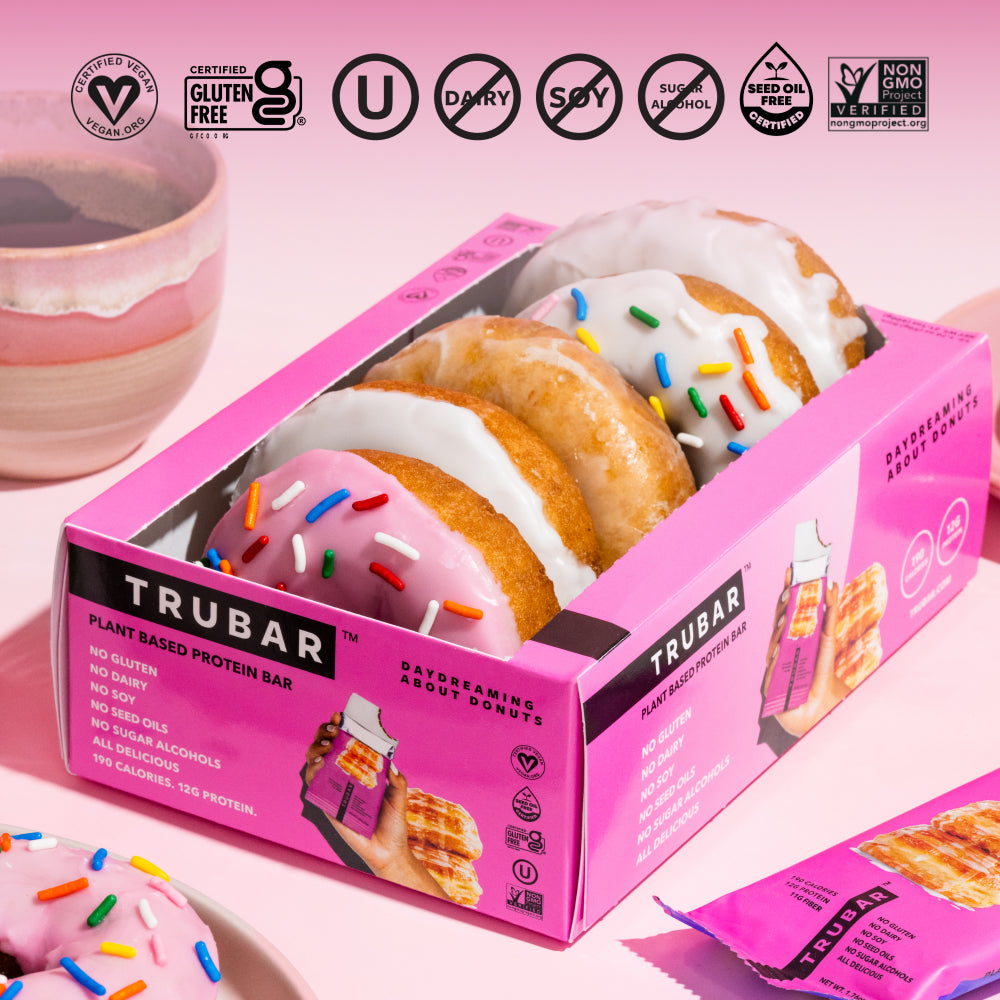 TRUBAR plant-based protein bar in a pink box with frosted glazed donut pieces.