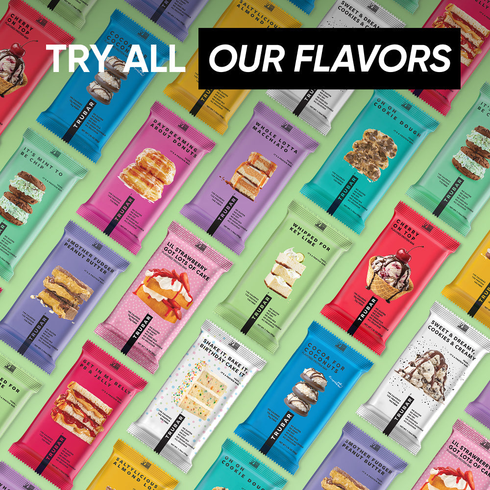 Assorted TRUBAR protein bar pouches in multiple flavors, colorful wrappers