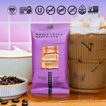 Purple protein bar pouch beside a cup of coffee and a creamy drink