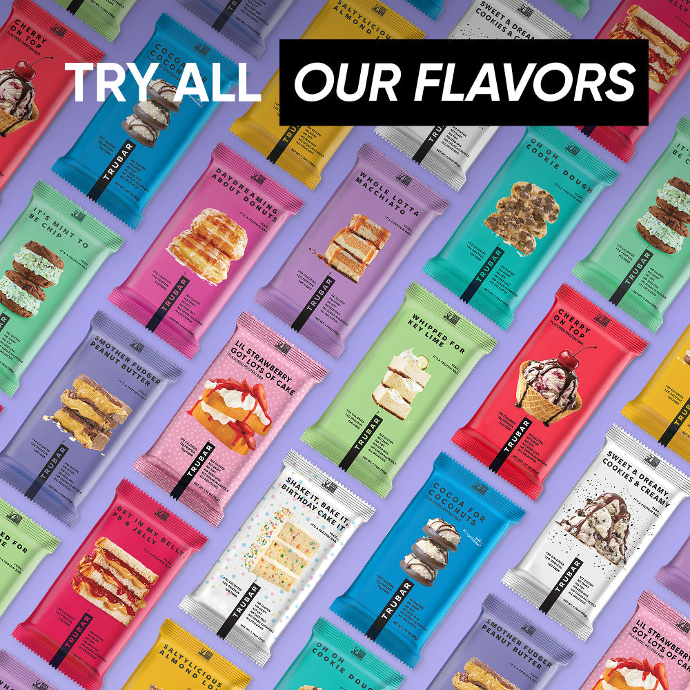 Colorful assortment of TRUBAR protein bar packs on a vibrant display