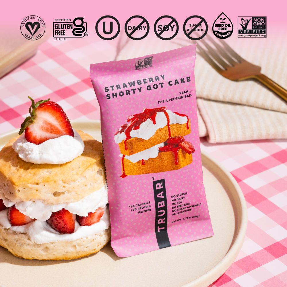 TRUBAR Strawberry Shorty Got Cake protein bar with strawberry and cashew snack on plate