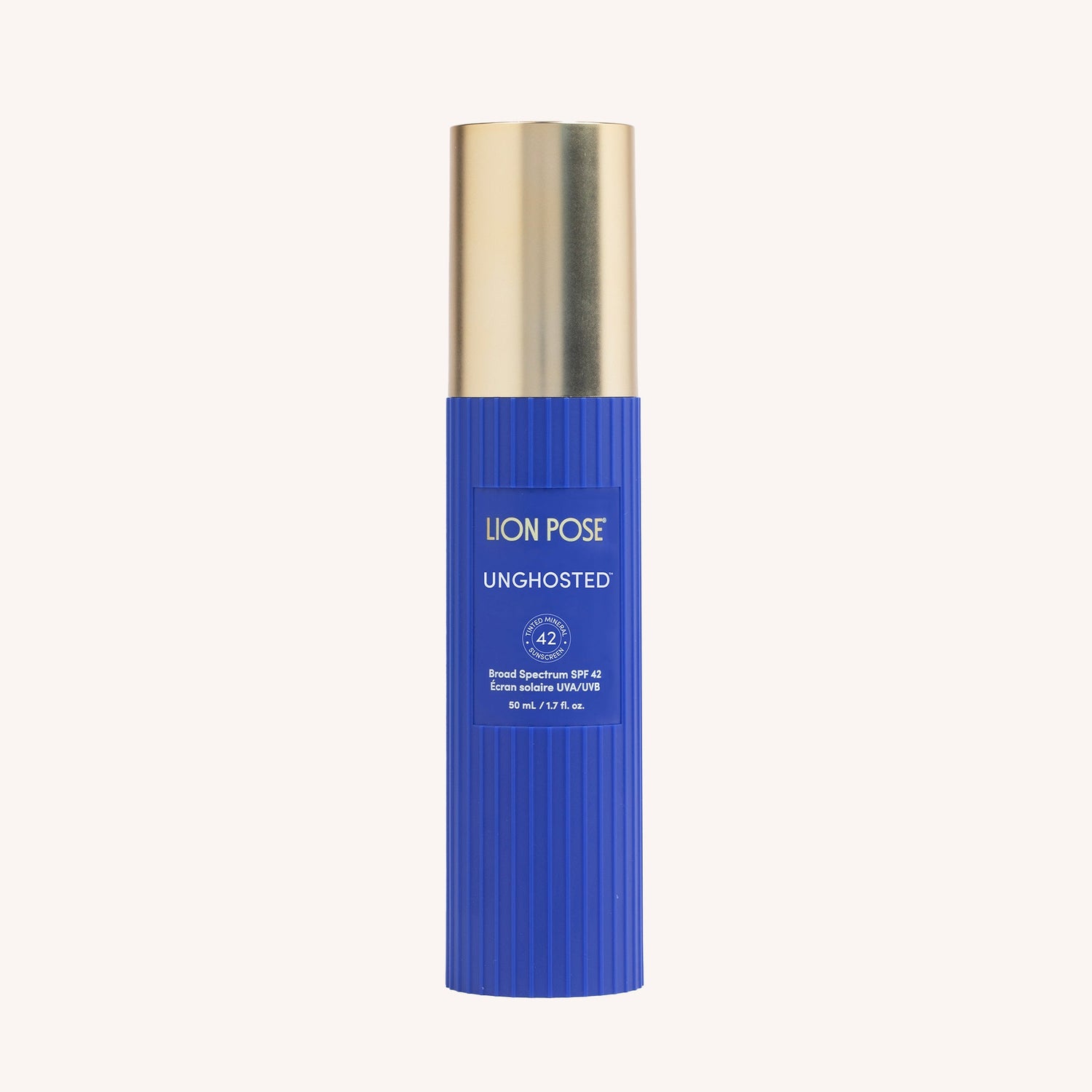 Tinted mineral SPF sunscreen bottle with blue ribbed label and gold cap