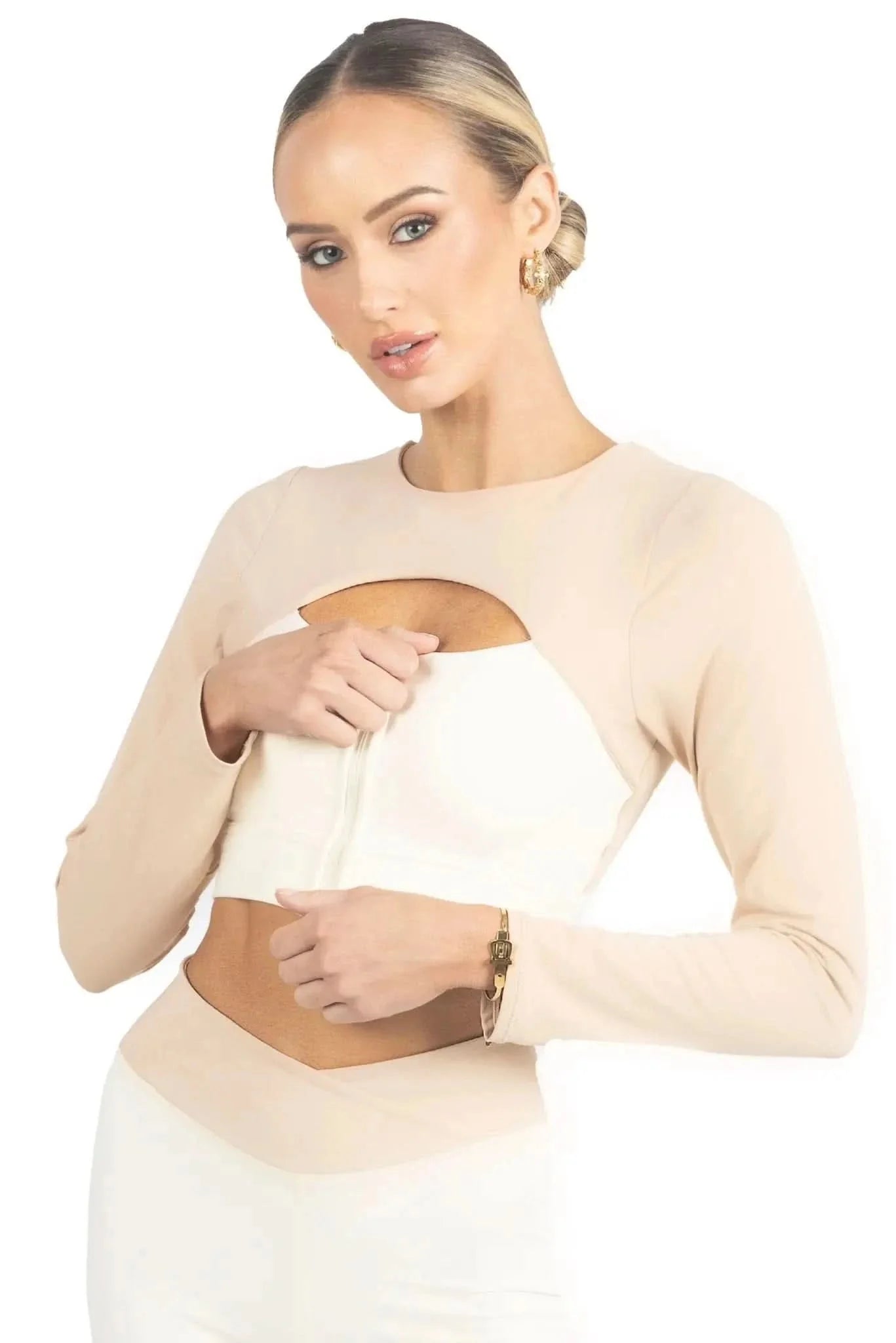 Beige long-sleeve activewear top with color-block cutout at the midriff