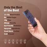 AMRITA chocolate protein bar in hand, dark bar texture