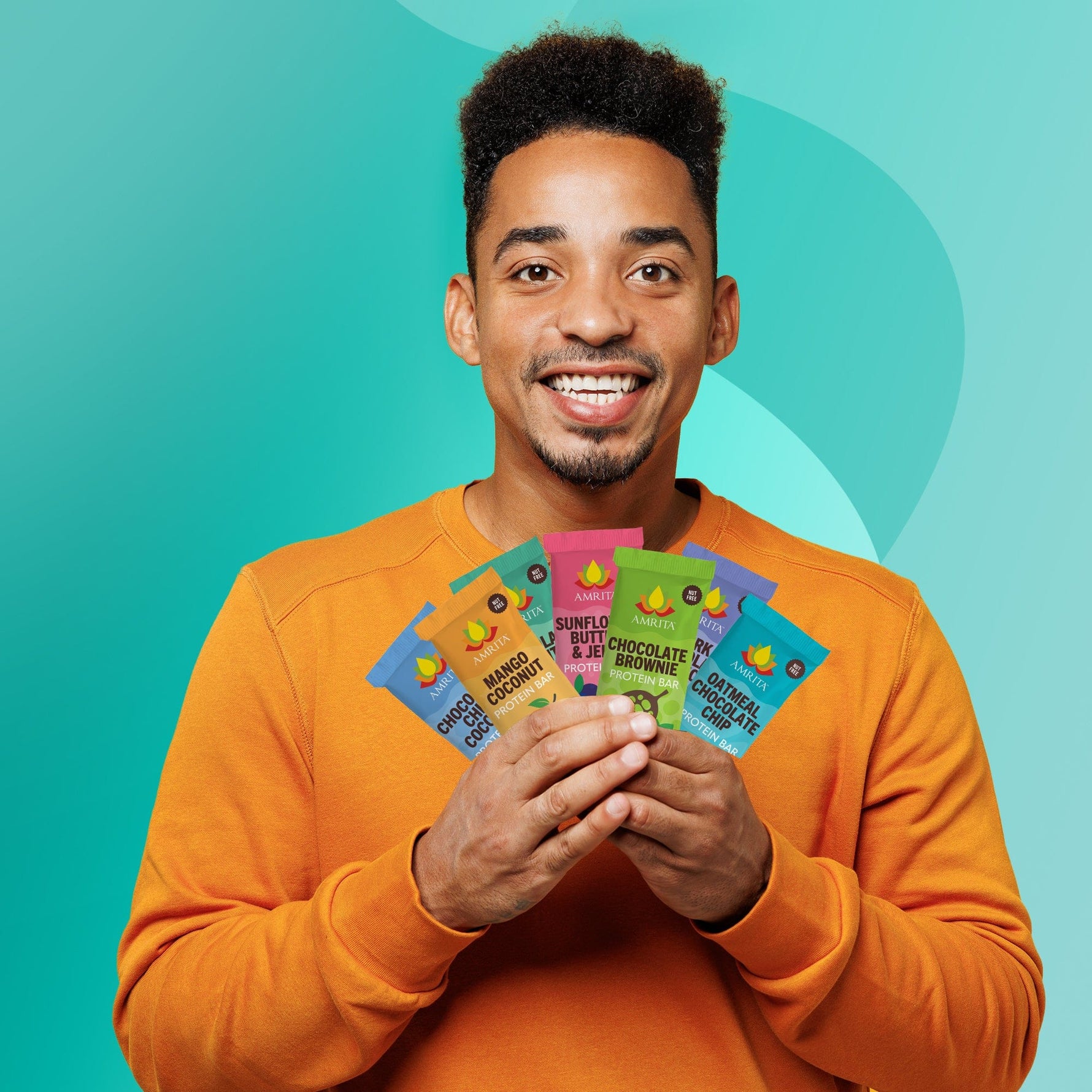 Assorted Amrita protein bars starter pack held by a smiling man, multiple wrappers