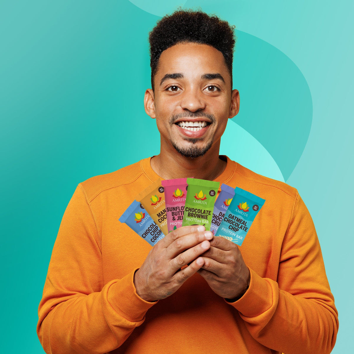 Man holding mixed protein bar variety pack wrappers