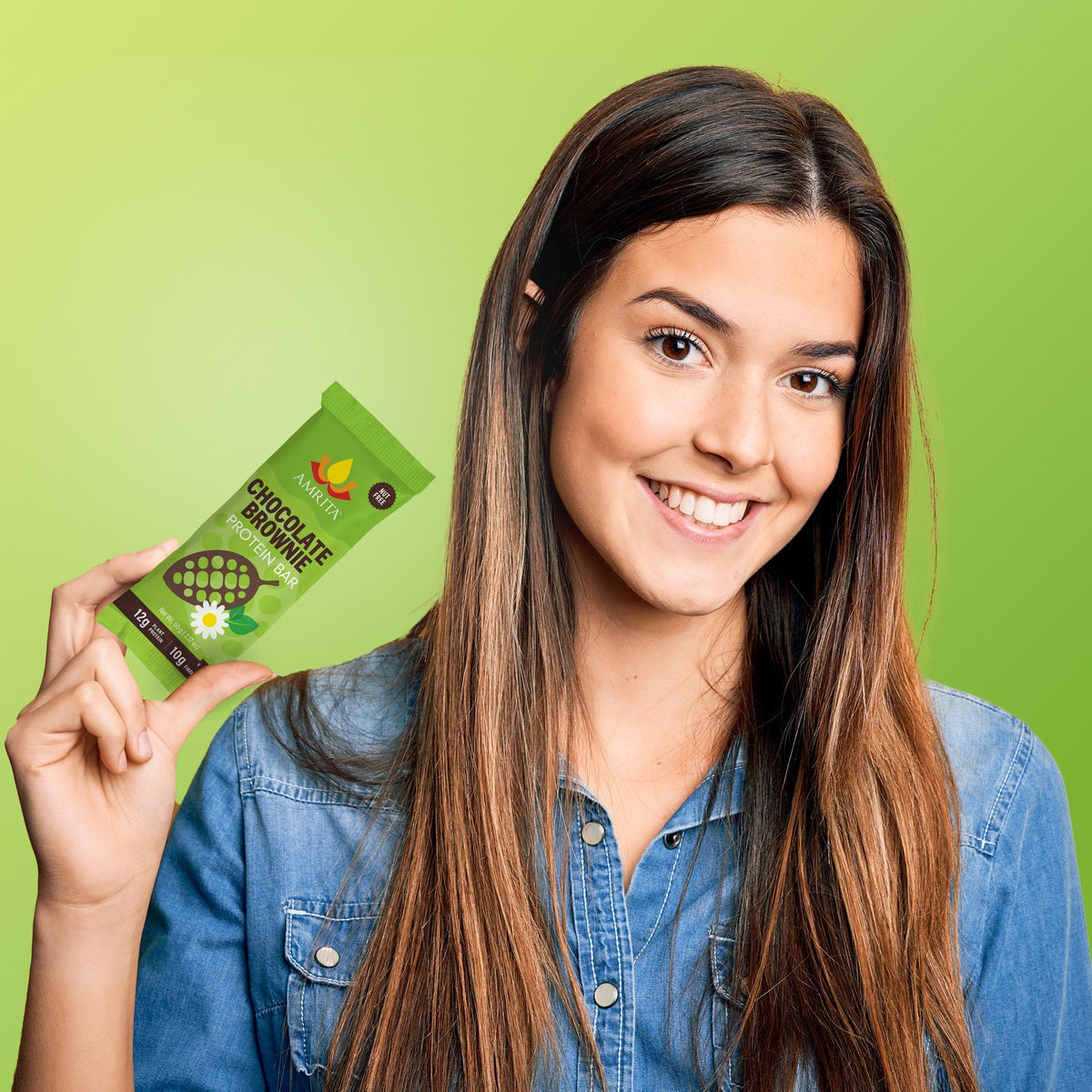 Green chocolate brownie protein bar in hand, small snack pack wrapper with logo.