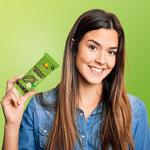 Green chocolate brownie protein bar in hand, small snack pack wrapper with logo.