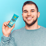 Oatmeal chocolate chip protein bar in teal wrapper held in hand