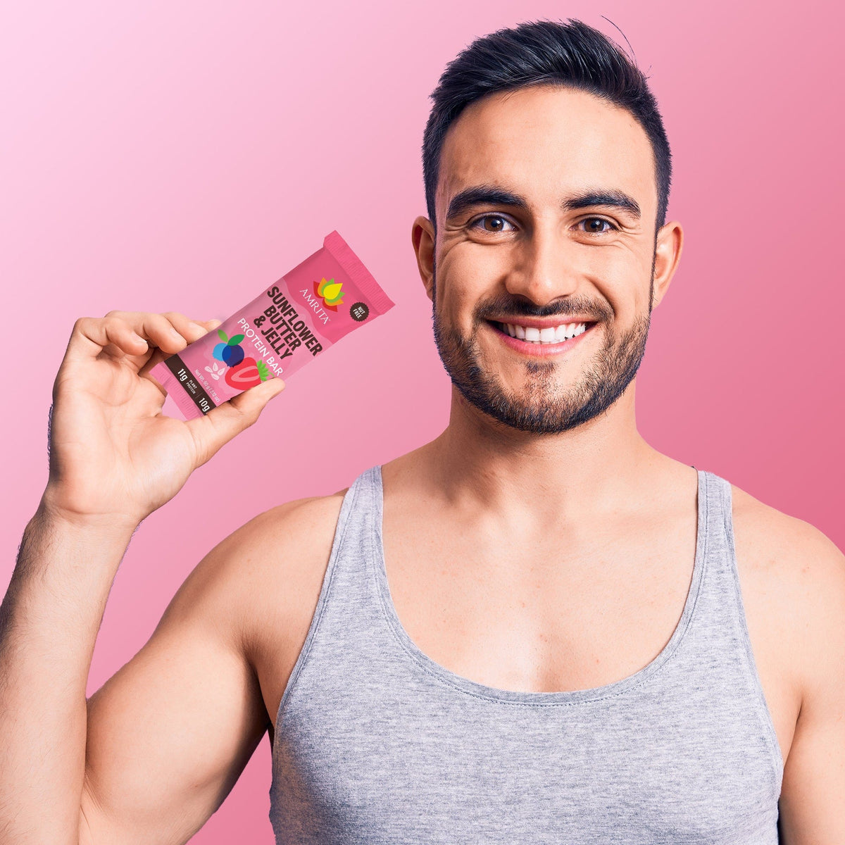 AMRITA protein bar pouch held in hand, front label facing forward