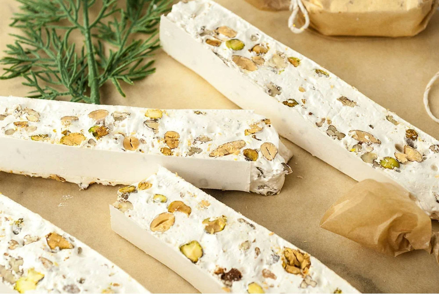 Gluten-free nut nougat brittle bars with mixed nut bits on parchment wrap
