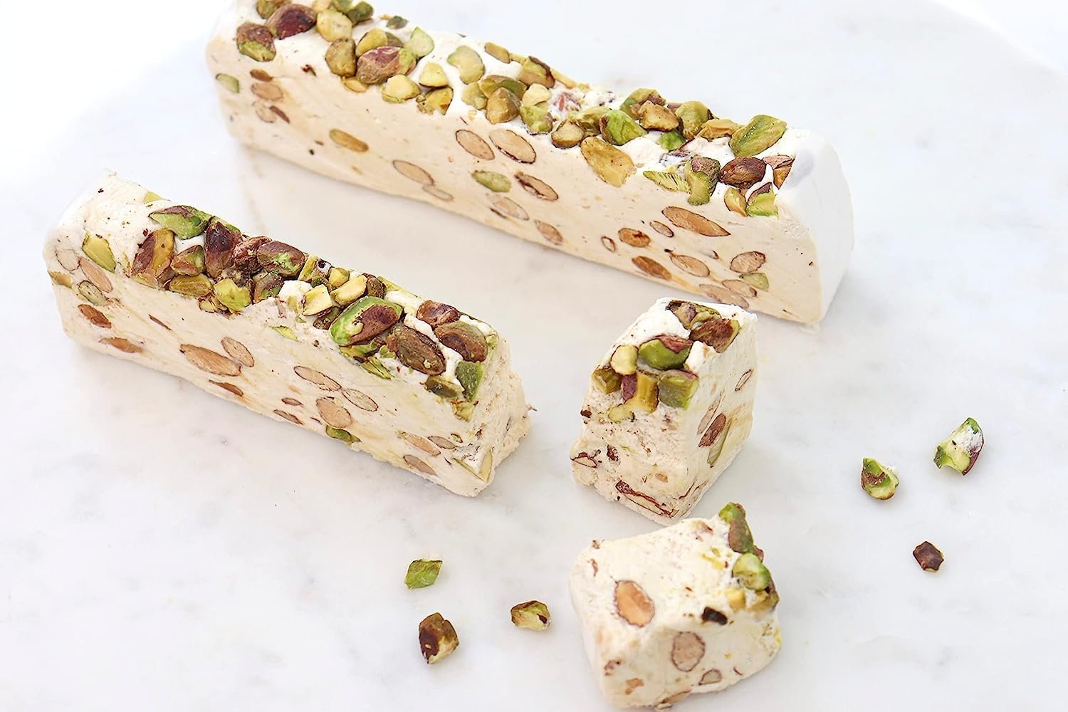Pistachio soft turron nougat slices with chopped pistachio pieces