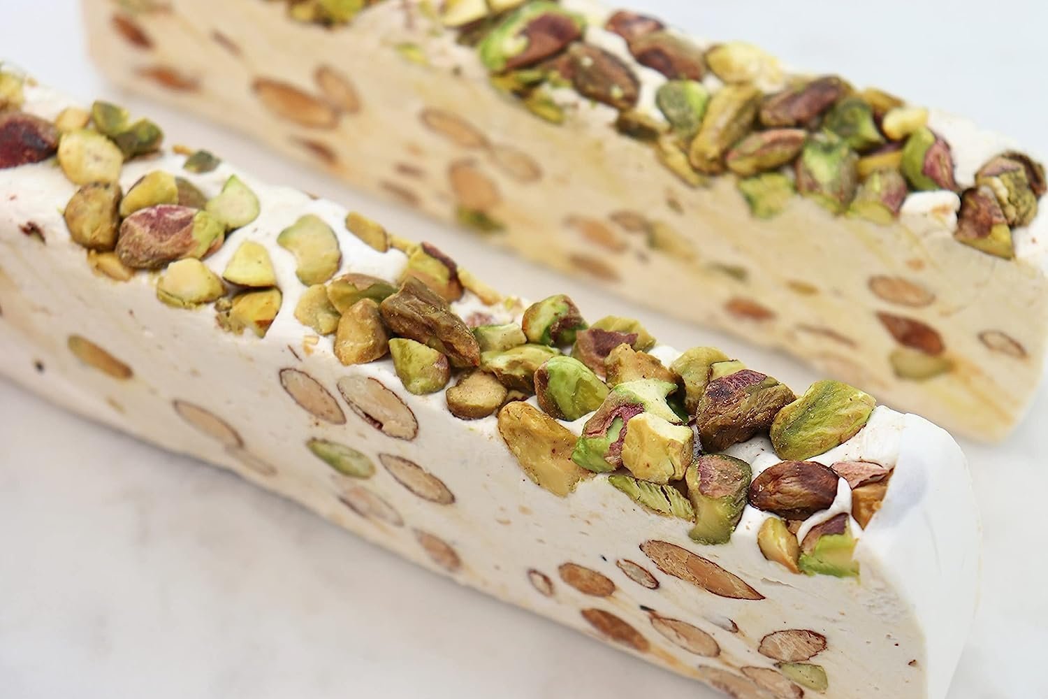 Pistachio soft turron nougat bar with chopped pistachios on top