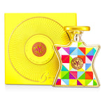 Eau de parfum bottle with geometric label, gold cap, with yellow gift box