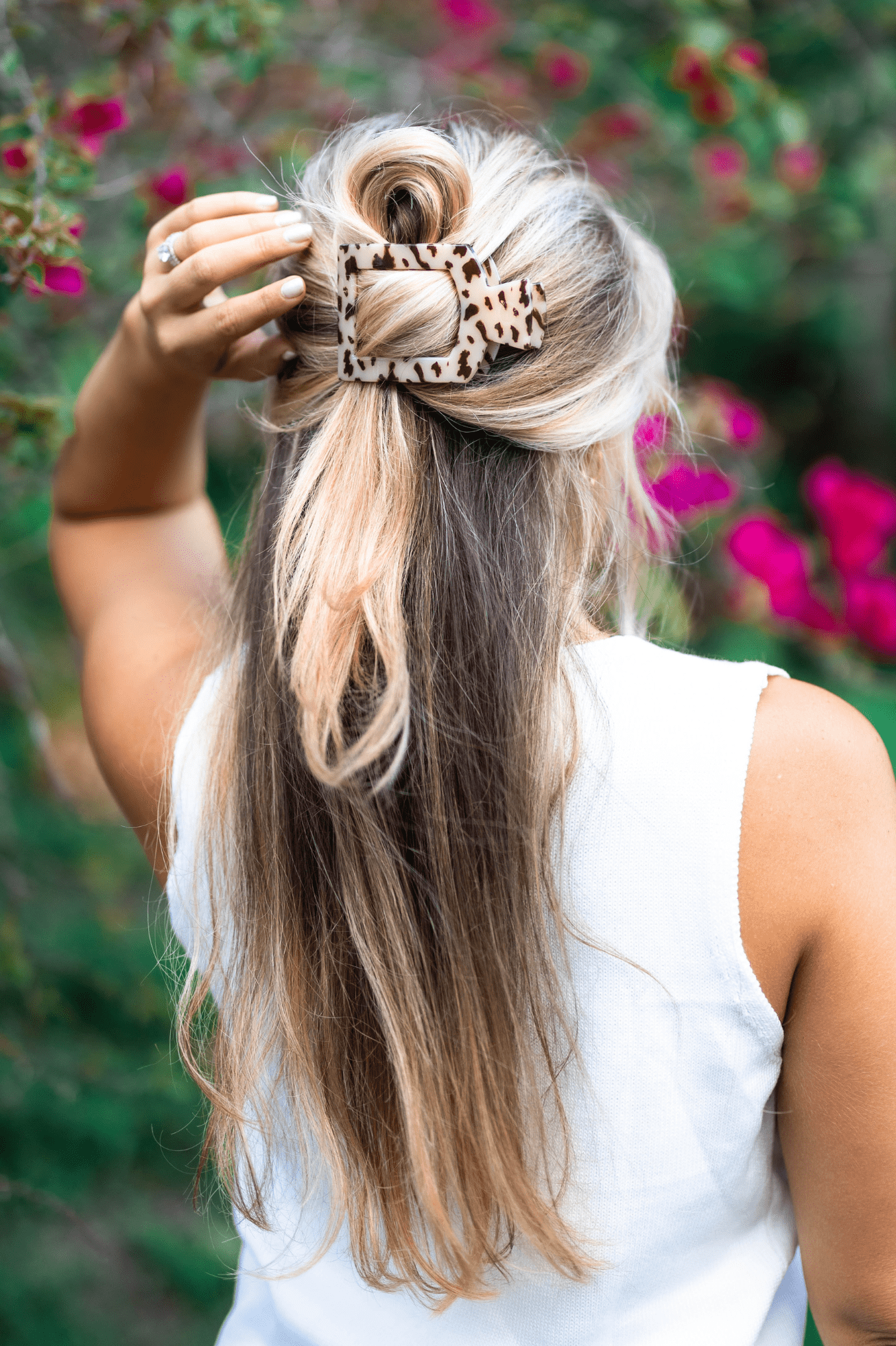 Large blonde tortoise square hair clip holding light hair in a top section
