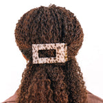 Medium flat rectangle tortoise hair clip on curly hair, beige and dark spot pattern