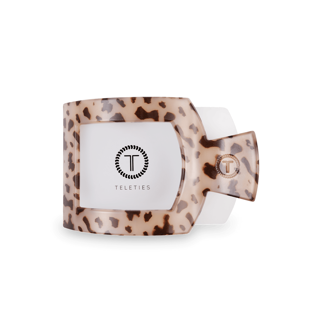 Flat square tortoise hair clip showing Teleties logo plate on beige leopard base.