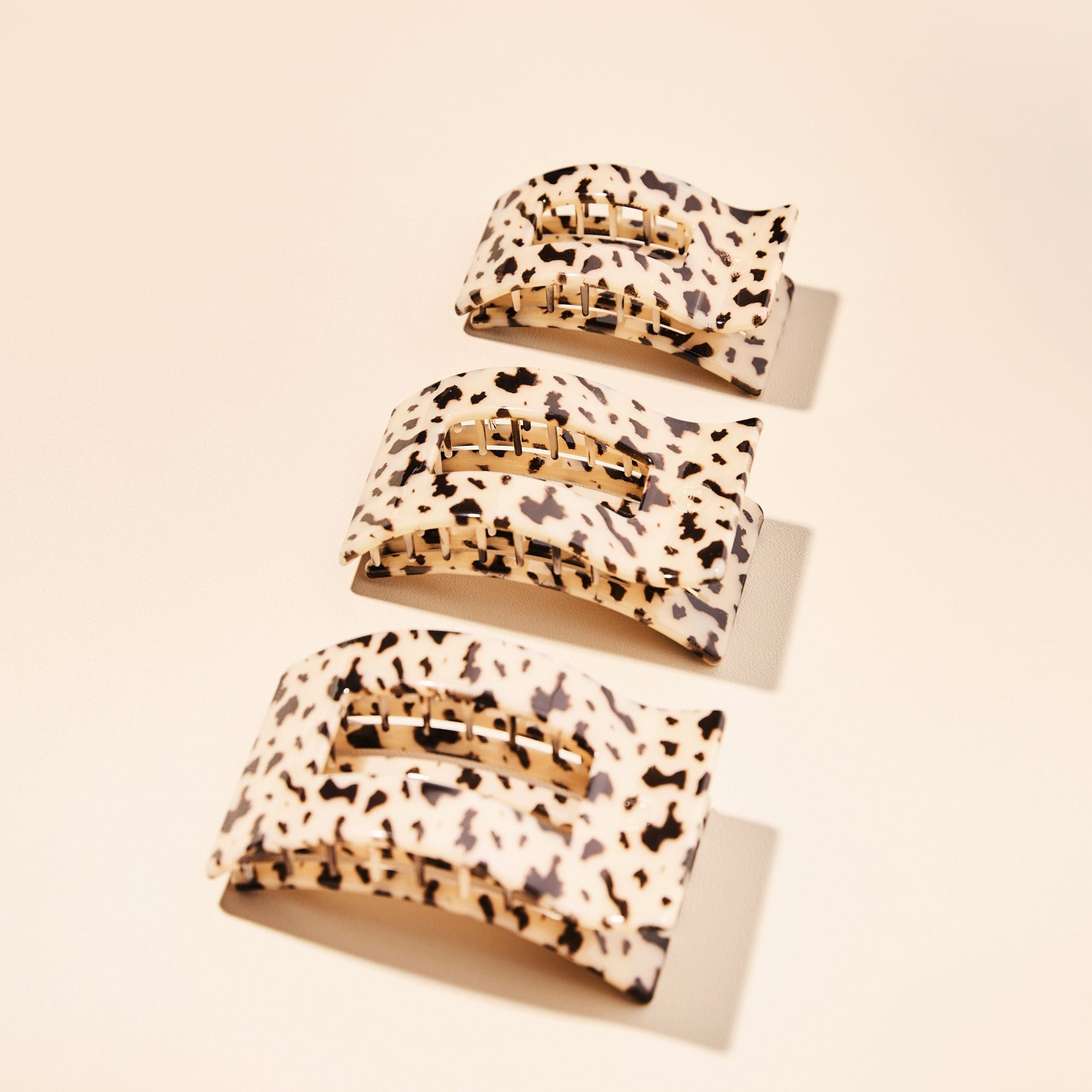 Three small rectangle hair clips in blonde tortoise pattern with gold-tone bars