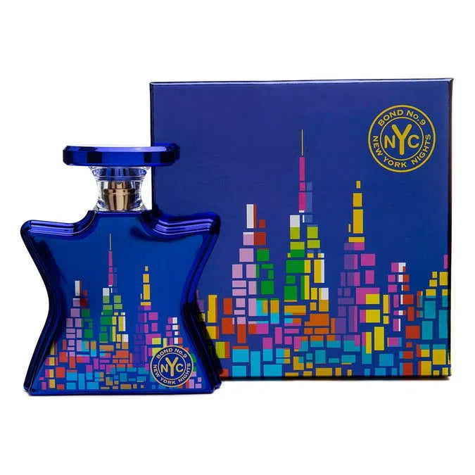 Blue perfume bottle and matching box with colorful skyline graphic and gold accents
