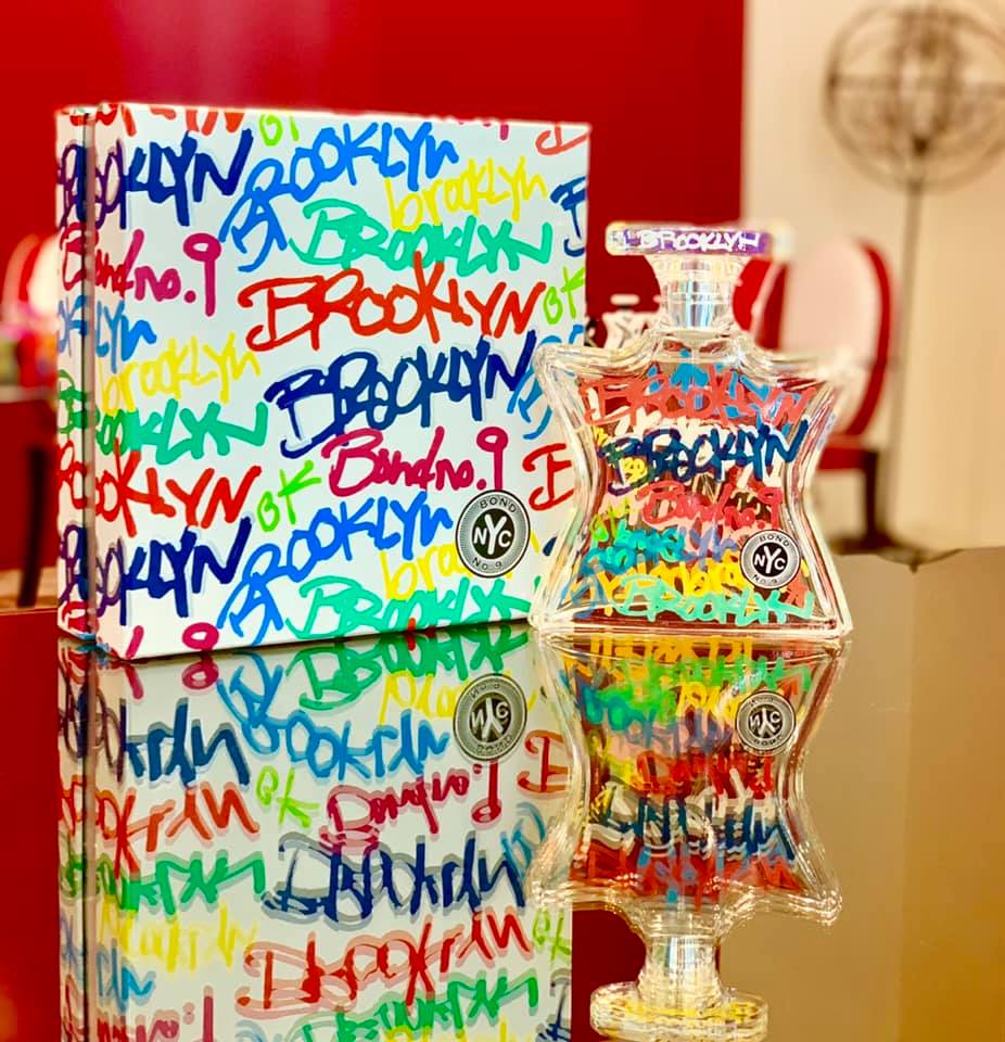 Eau de Parfum set with bottle and box featuring Brooklyn graffiti and NYC badge