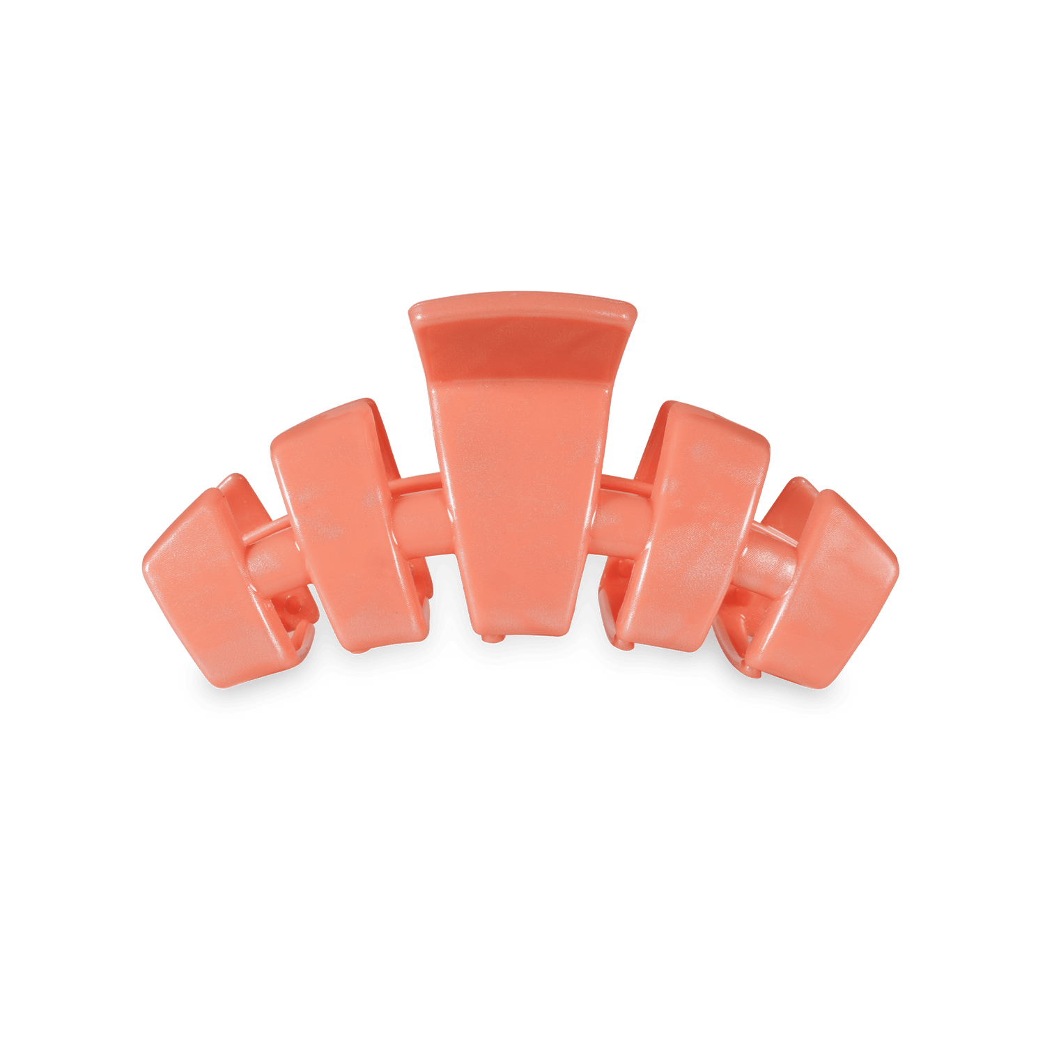 Small coral-orange claw clip with four curved teeth for holding hair.