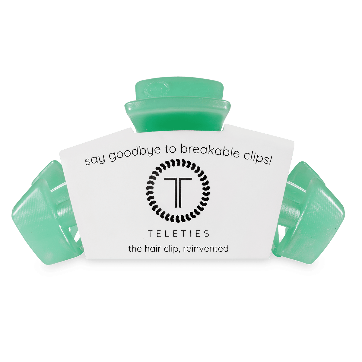 Mint green large claw hair clip with attached cardboard branding card