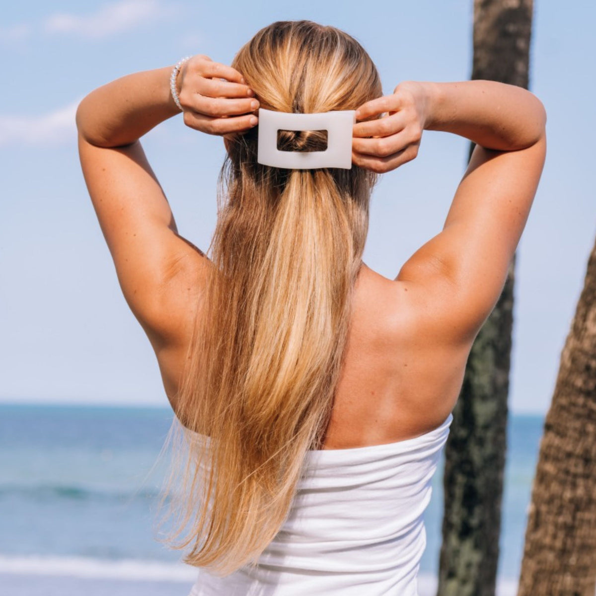 Large flat rectangle hair clip holding long blonde hair at the back