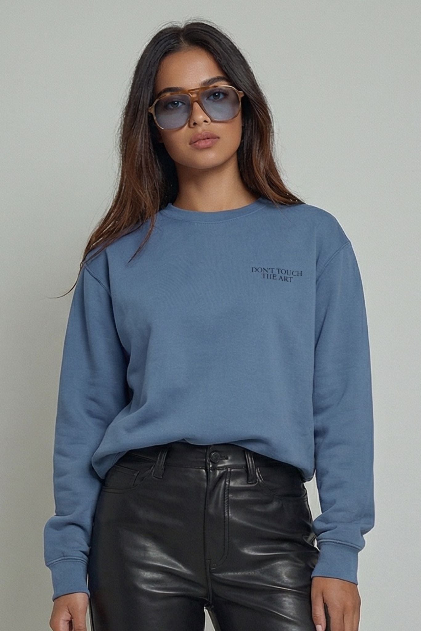 Blue crewneck sweatshirt with printed chest text "DON'T TOUCH THE ART"