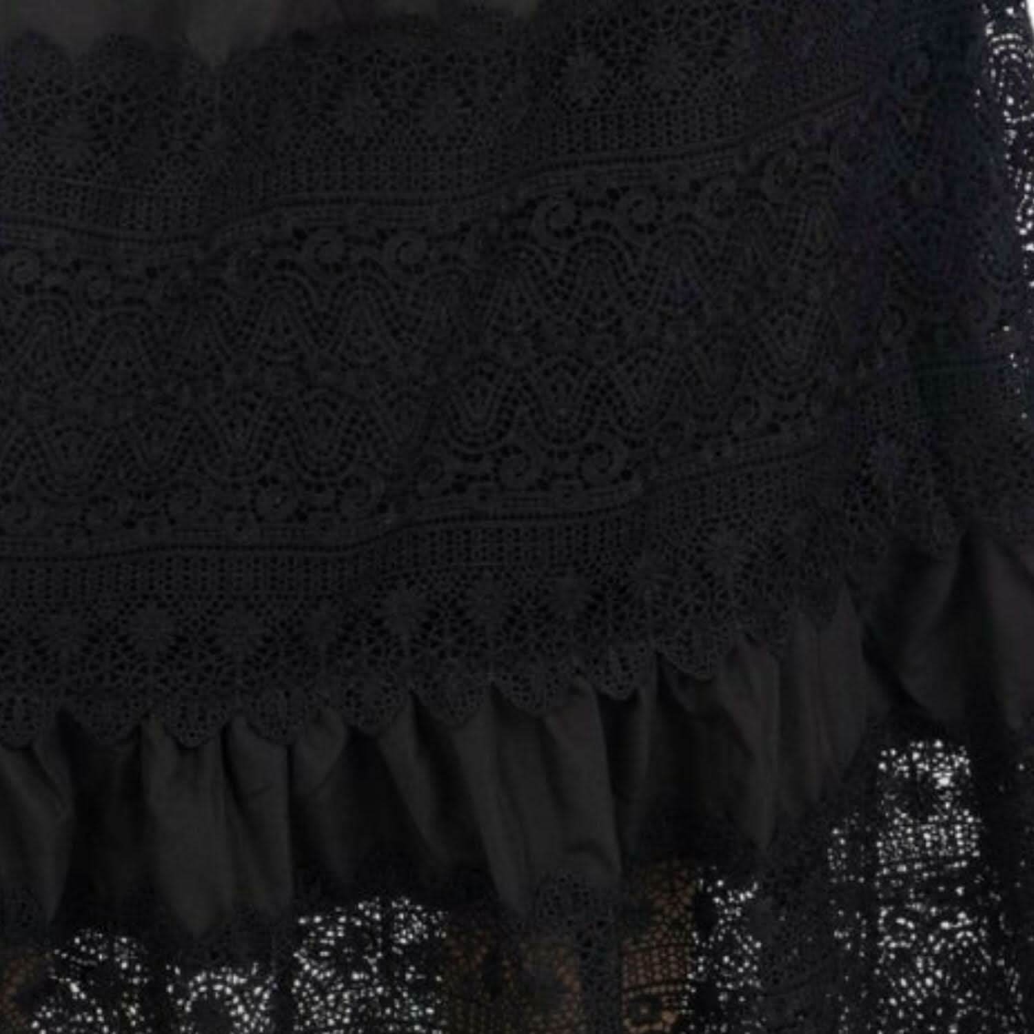 Close-up of black guipure lace and ruffled trim on the maxi skirt hem