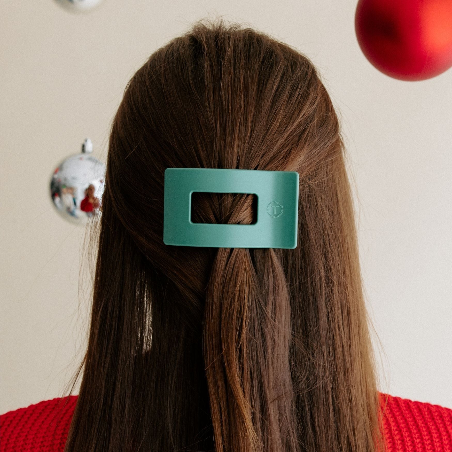 Fir Real small flat rectangle hair clip in teal, clipped on brown hair