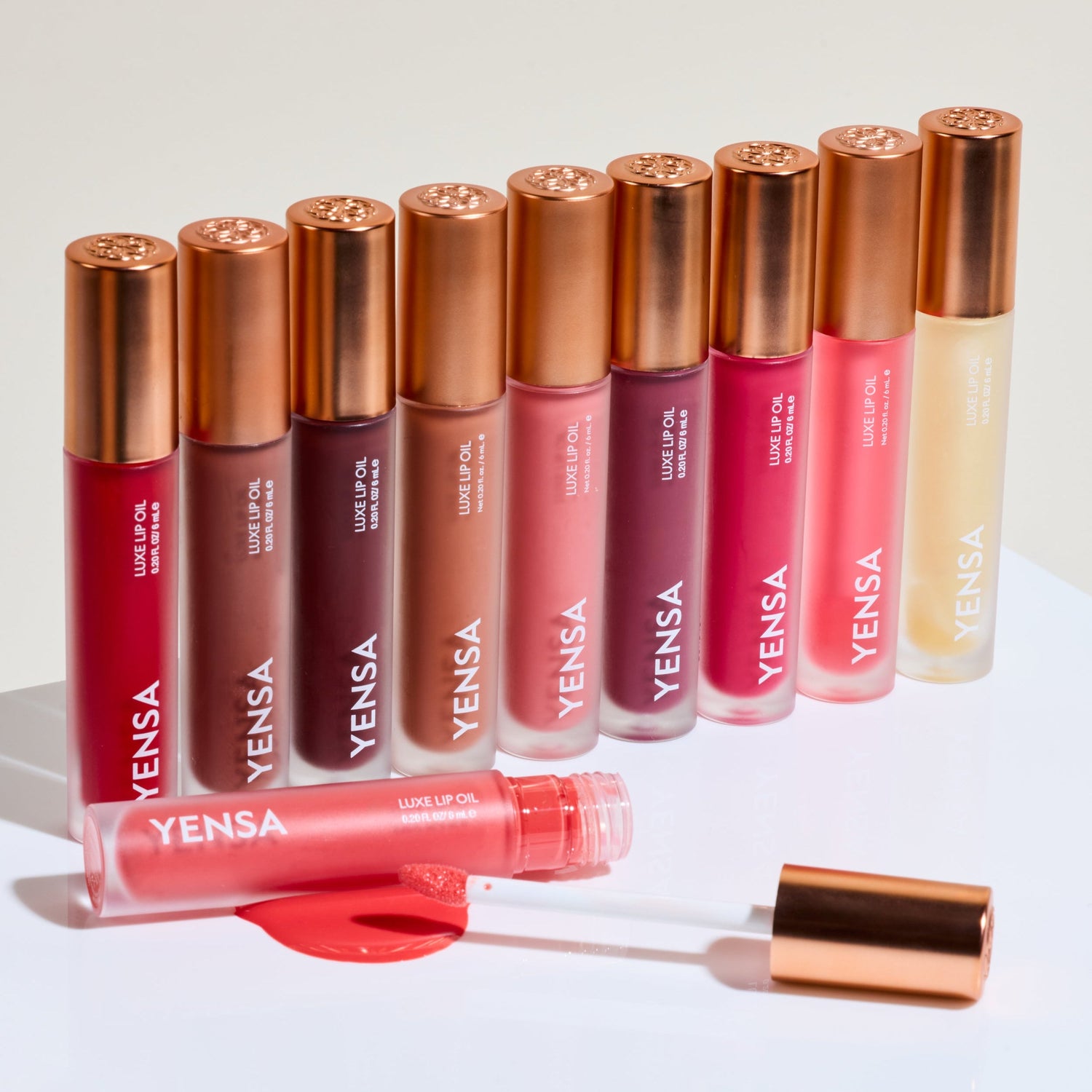 Luxe lip nourishing oil tubes with gold caps in pink and clear shades