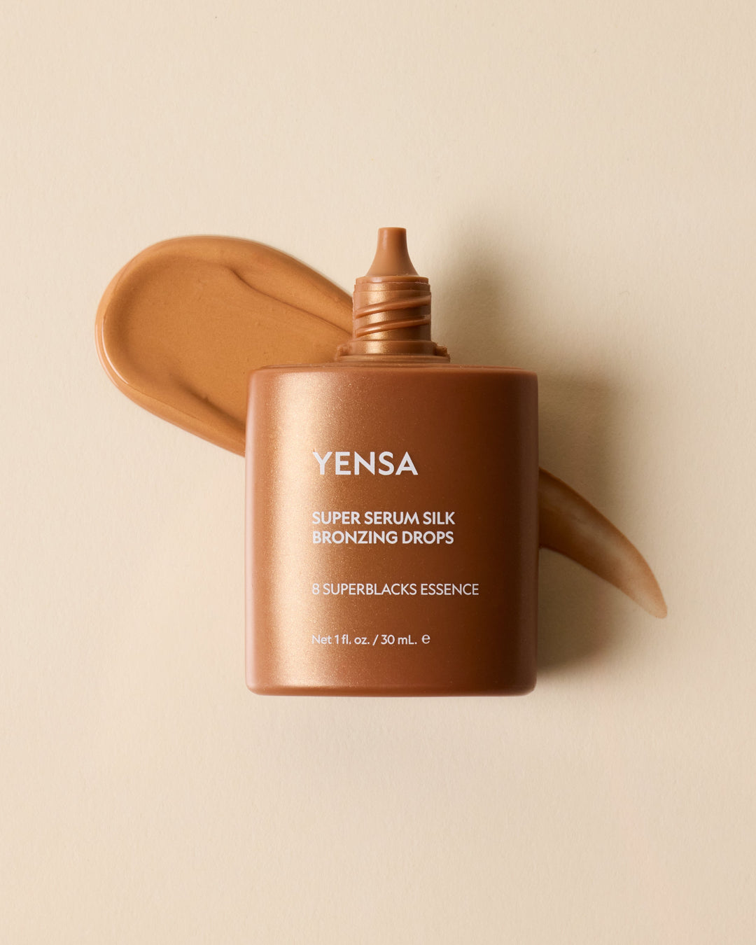 Bronzing serum silk drops bottle with bronze gel swatch behind
