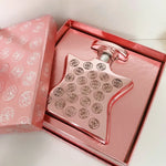 Eau de Parfum bottle in gift box, rose-pink glass with silver-toned cap