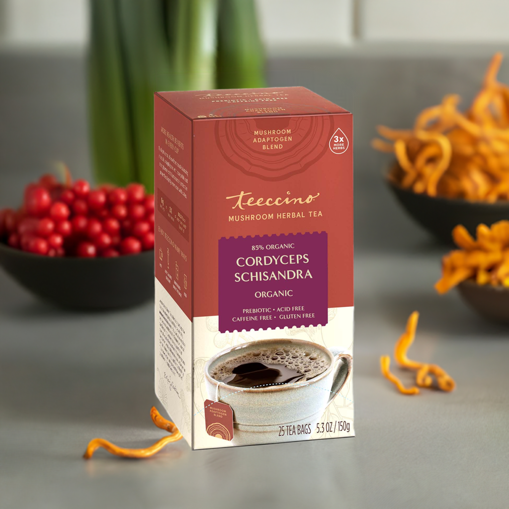 Teecino cordyceps schisandra mushroom herbal tea box with cup, herbs nearby