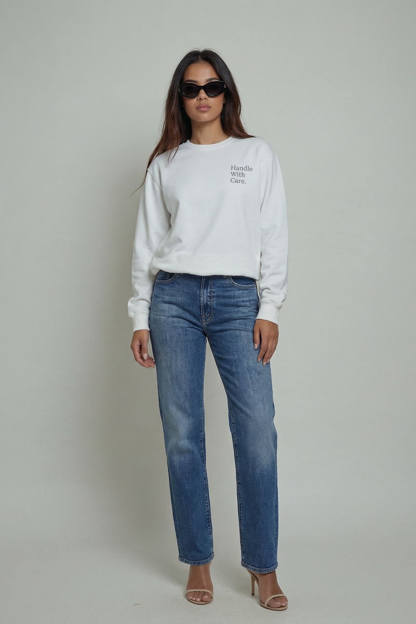 White crewneck sweatshirt with "Handle With Care" print, long sleeves