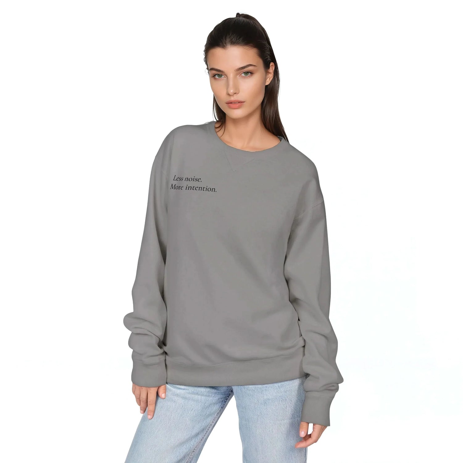 Concrete grey pullover sweatshirt worn with jeans; crew neck, long sleeves, chest slogan.