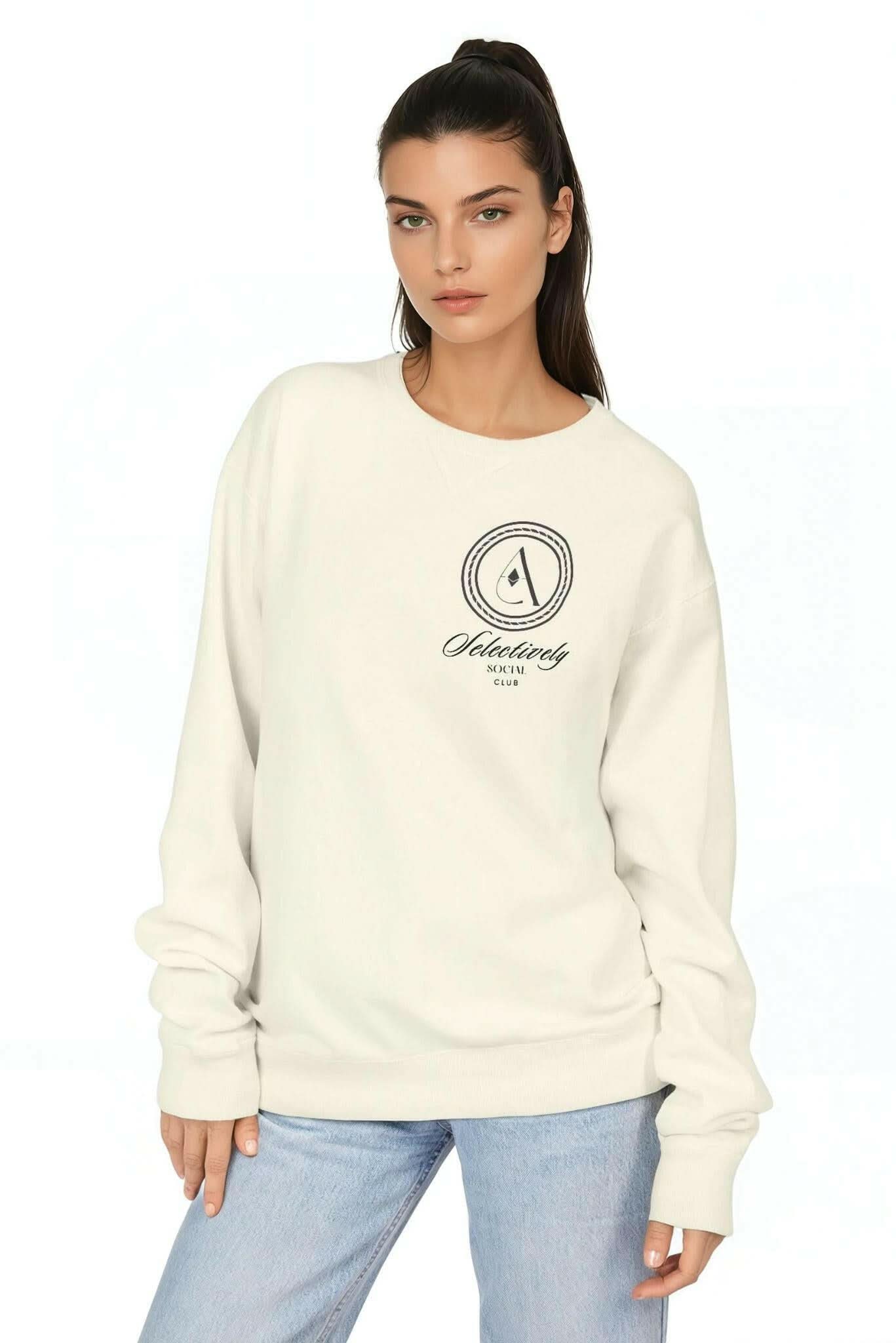 Parchment crewneck sweatshirt with small circular logo graphic at center chest