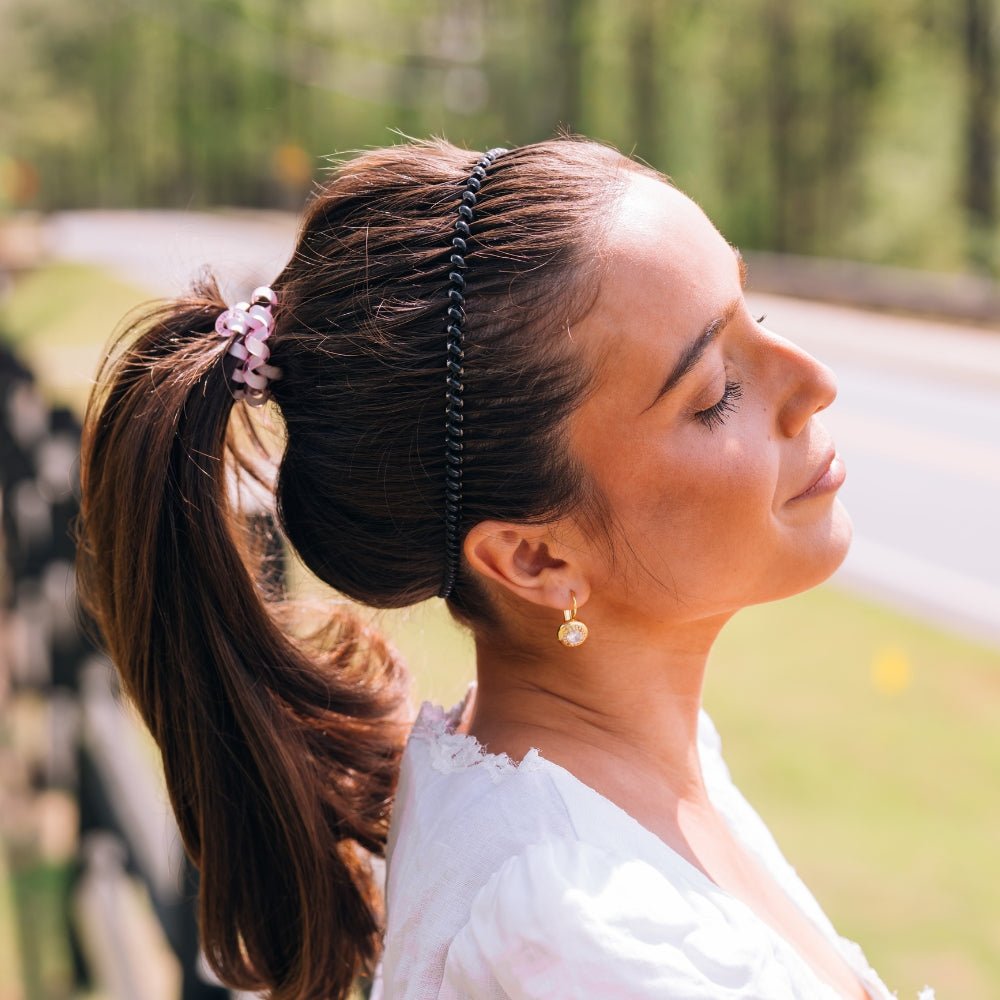 Black beaded headband worn in side-part hairstyle with small front charm